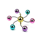 Close up of the gold hub with six curved wire arms holding chrome coloured balls