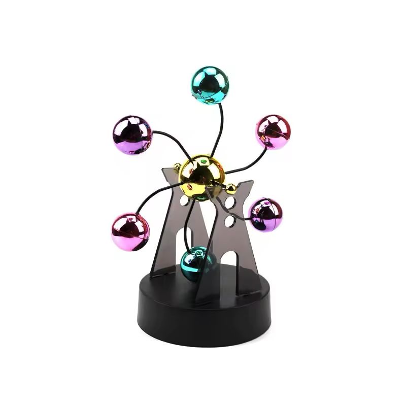 Kinetic desk gadget with a gold hub and six teal, pink and purple chrome balls on wire arms
