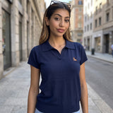 Navy knit polo top with a flat shirt collar and ribbed sleeve cuffs