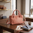 Coral knotted handle mini tote with a detachable crossbody strap