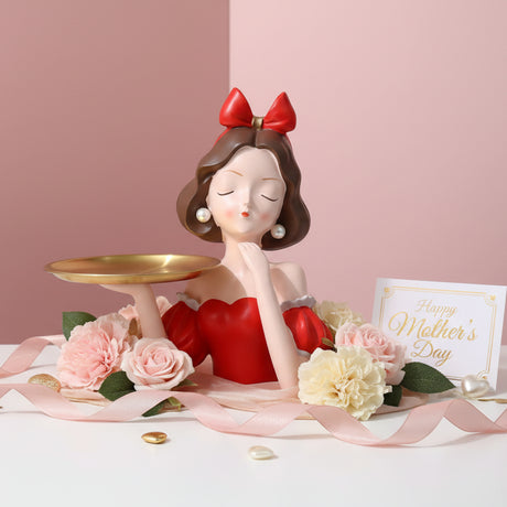 Brunette in a red ruffled dress with her gold tray, carnations and a card beside her