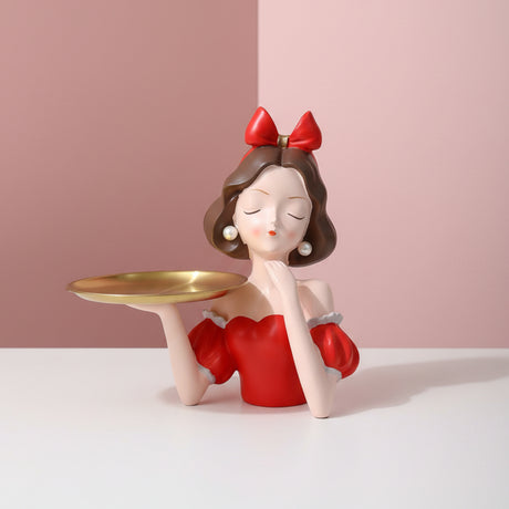 Red bow and red off shoulder dress, chin on hand, gold tray out on one arm