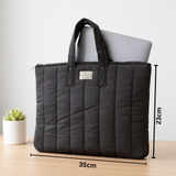 Black quilted laptop sleeve with size measurements