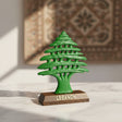 Green open tier cedar tree statue on a dark wooden base lettered Lebanon