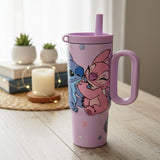 Lilac Stitch and Angel tumbler styled with books, a candle and fairy lights