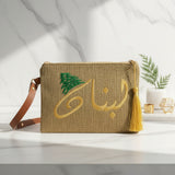 Jute zip pouch with the Arabic calligraphy in gold thread, a leather strap and tassel