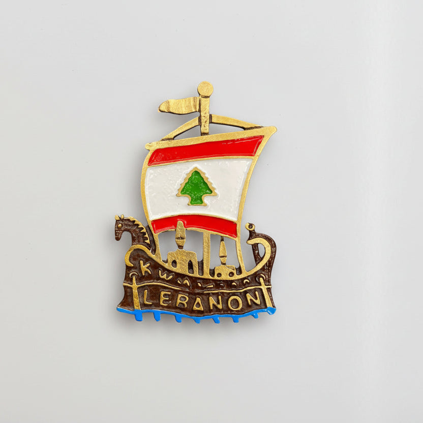 Phoenician ship magnet in antique bronze with a flag sail and blue enamel waves