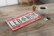 Novelty car plate in red and white spelling Lebanon with a cedar tree as a letter
