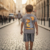 Child walking down a cobbled street in an urban setting with a cartoon t-shirt on