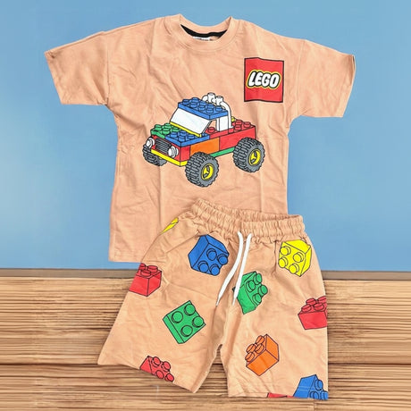 Beige boys two piece set, tee with a block truck graphic and brick print shorts laid flat