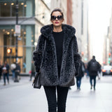 Woman wearing a black fur coat with leopard print design on a city street