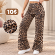 Leopard print high waisted wide leg pants worn with a white crop top and white trainers, with a fabric close up