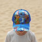 Boy in a grey shirt wearing an all blue kids cap covered in colourful cartoon character art
