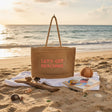 Beige straw Let's Get Beaching tote bag on the sand – Jack Gifts Online Lebanon