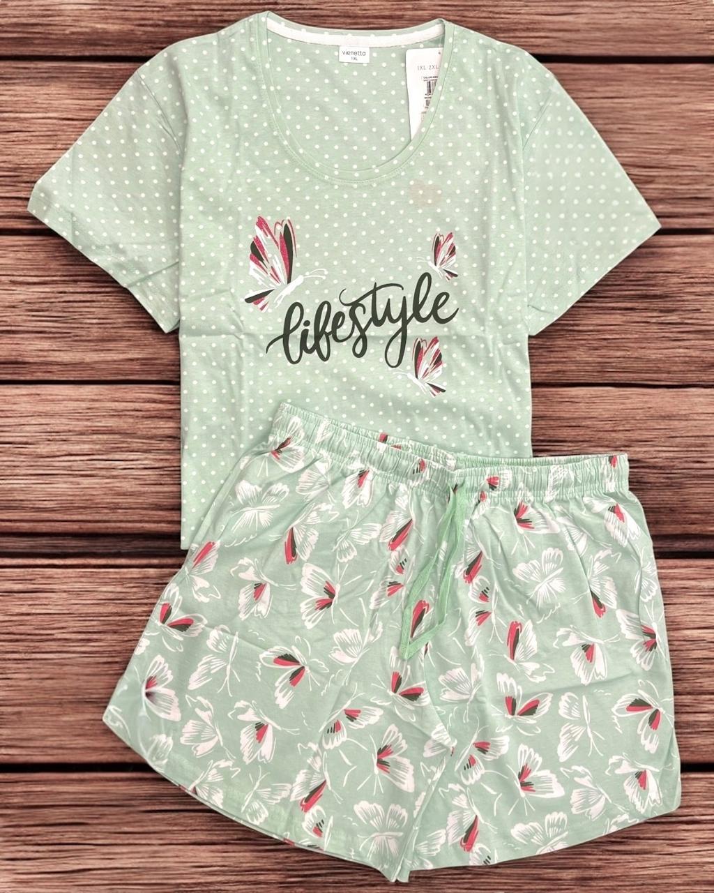 Green pajama set with floral patterns on a wooden surface