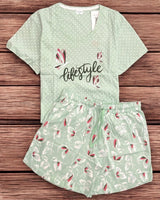 Green pajama set with floral patterns on a wooden surface