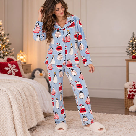 Light blue penguin print pajama set with a notch collar, button front and chest pocket in a holiday room