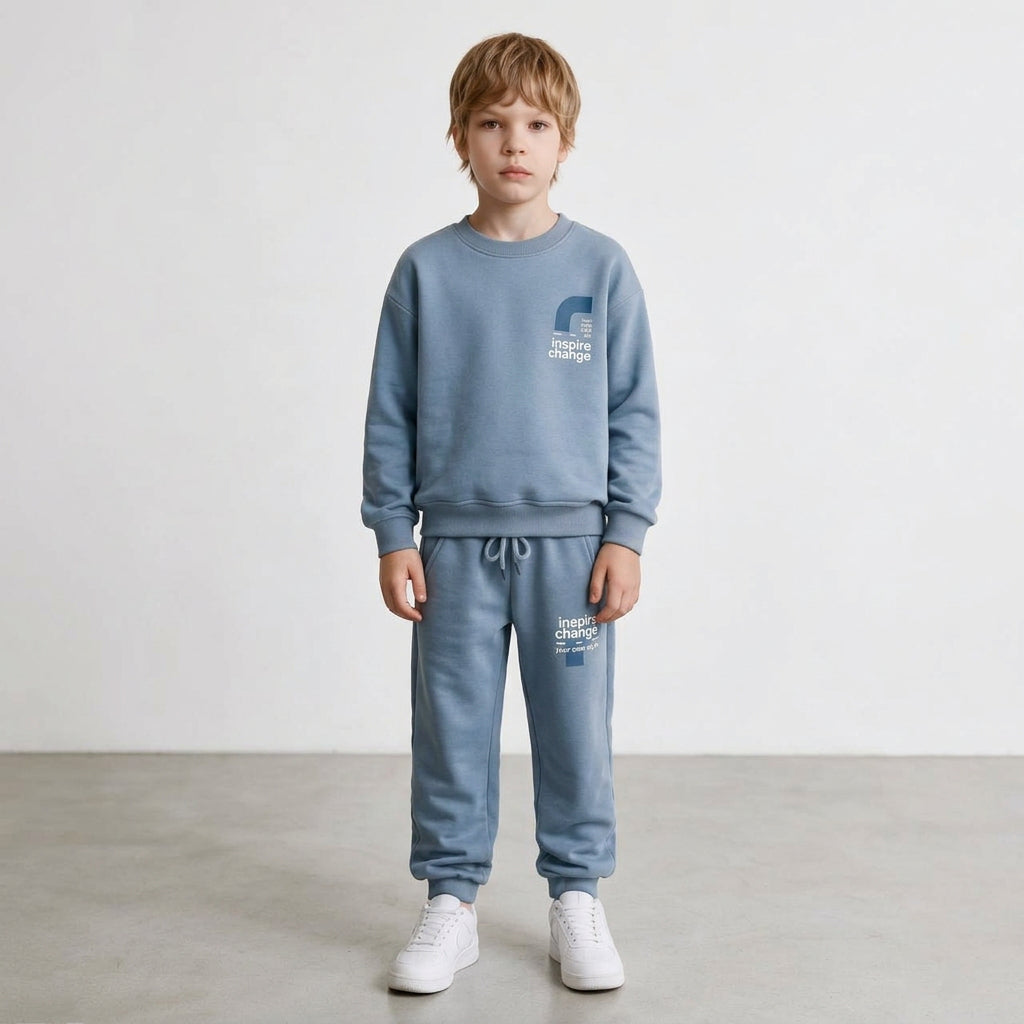 Boy in a light blue crew neck sweatshirt and drawstring joggers
