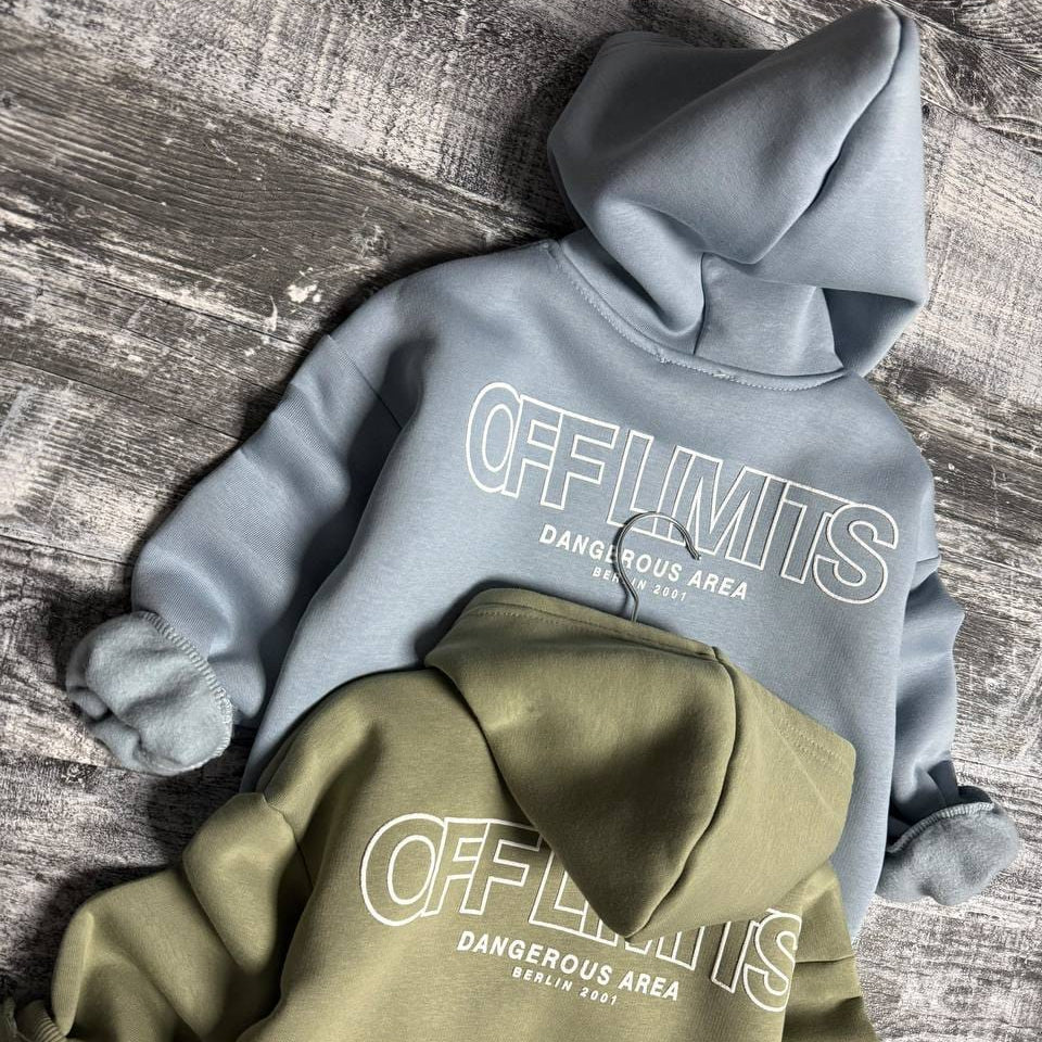 Light blue and sage green off limits hoodies laid flat together