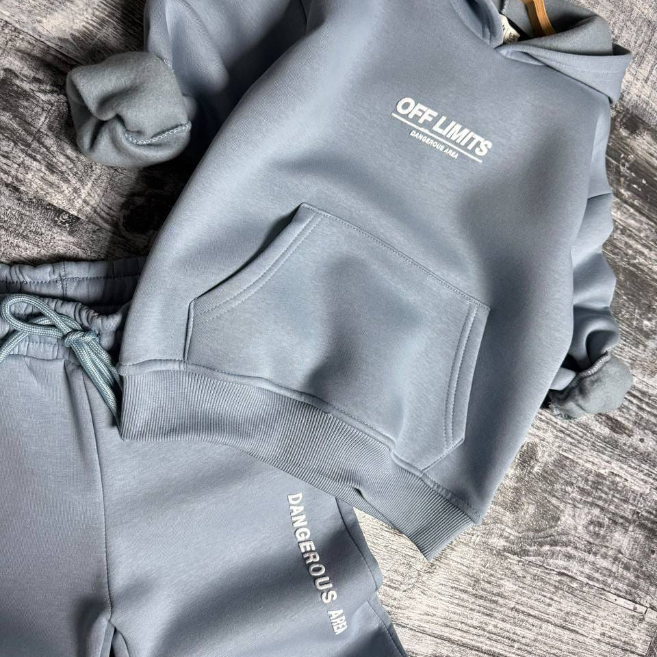 Light blue hoodie with kangaroo pocket and matching joggers laid flat