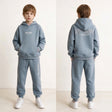 Boy shown front and back in a light blue hoodie set with off limits back print