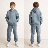 Boy shown front and back in a light blue hoodie set with off limits back print