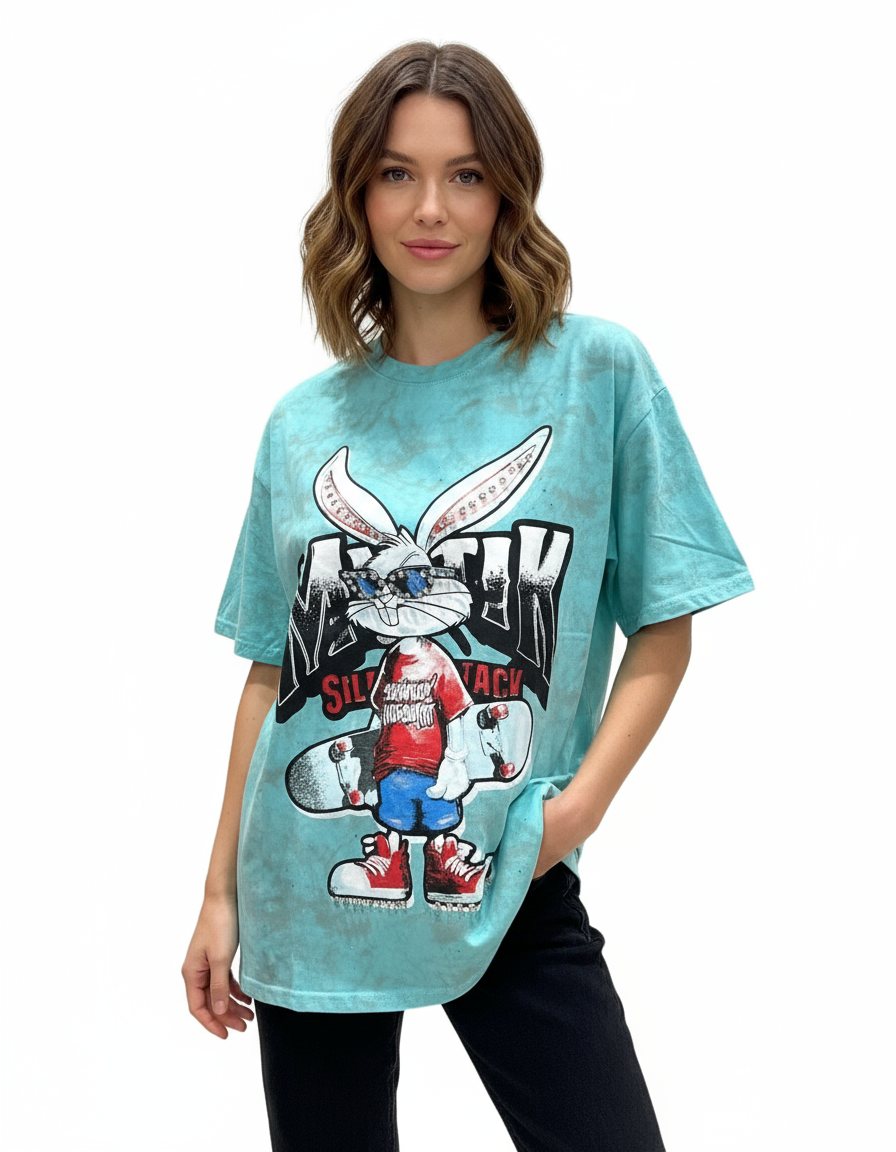 Woman wearing a light blue tshirt with a graphic bunny  design on a white background