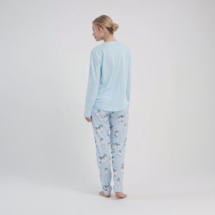 Light blue women's pyjama set with penguin top and animal print pants on a white background