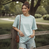 Woman wearing a light blue tshirt outdoors in nature