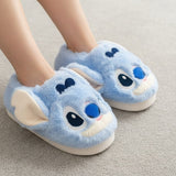 Blue cartoon slippers with a stitch face design on a neutral background
