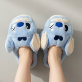Blue cartoon slippers with a stitch face against a neutral background