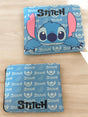 Light blue bifold wallet open flat showing an all over watermelon and Stitch face pattern