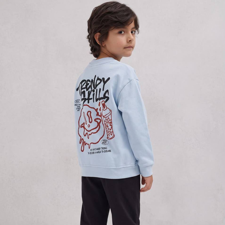 Boy looking over his shoulder showing the graffiti smiley back print