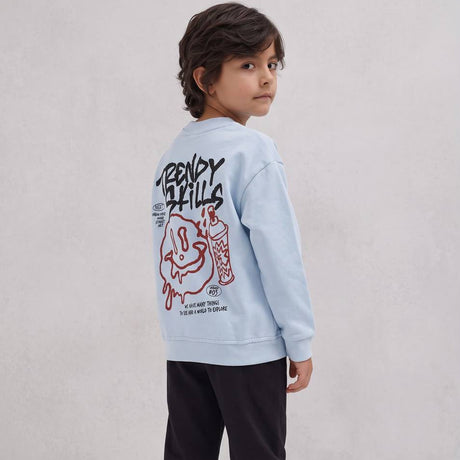 Boy looking over his shoulder showing the graffiti smiley back print