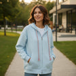 Woman in light blue oversized zip hoodie with pink tassel drawstrings, Jack Gifts Online Lebanon