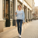 Attached cream shirt collar shown at the neckline of the light blue sweatshirt