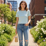 Woman wearing light blue crop top outdoors