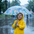 Boy in a yellow raincoat holding a light blue tropical stitch umbrella with a blue hook handle