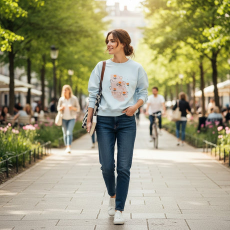 Light blue tulip print sweatshirt worn walking a leafy path in spring
