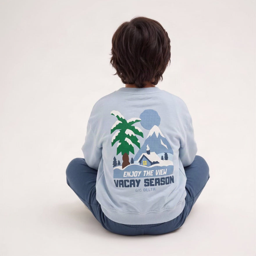 Boy sitting with his back turned showing the palm tree Vacay Season print