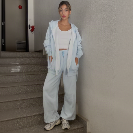 Pale blue velour worn head to toe on stone steps with trainers