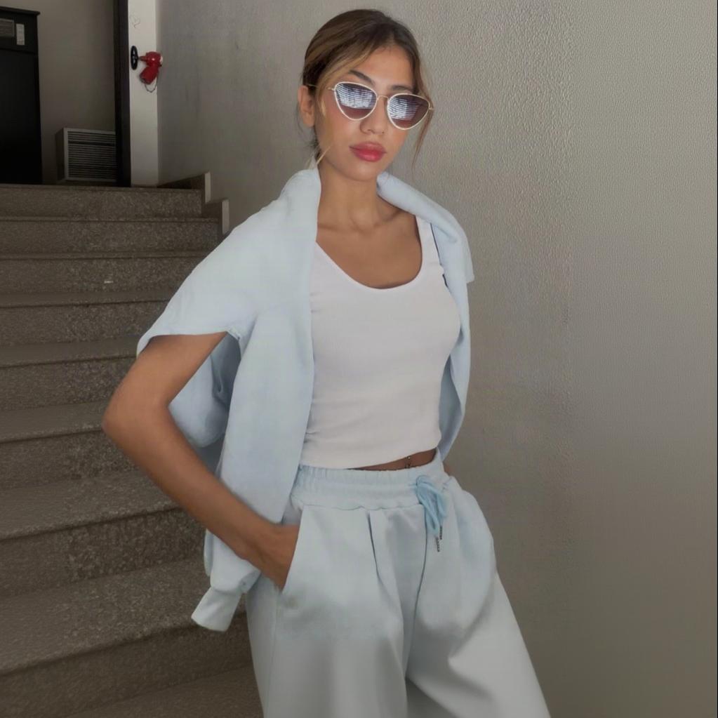 Short sleeve blue velour top and matching wide leg pants on a city street
