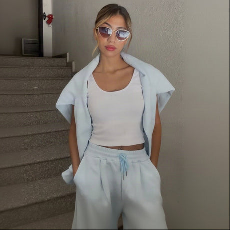 Pale blue velour set styled with round sunglasses and a white tank