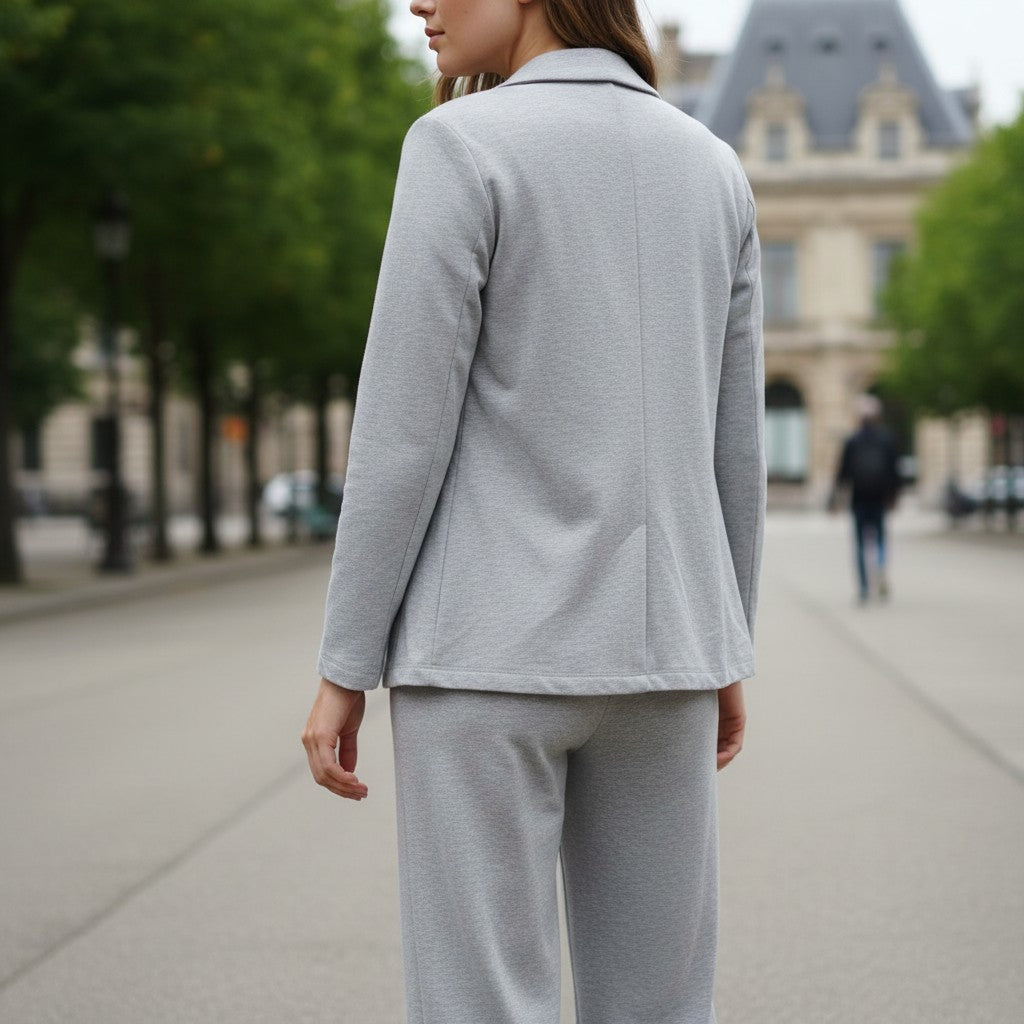 Back view of a light grey jersey blazer showing the centre vent and matching joggers