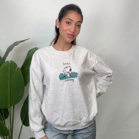 Light grey puppy scout sweatshirt with ribbed cuffs and hem in a hand on hip pose