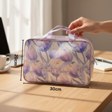 Light purple floral-patterned cosmetics bag with measurements 20x30cm on a wooden surface