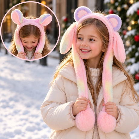 Girl in a cream coat wearing a lilac and pink ombre ear headband with fluffy pink pom poms
