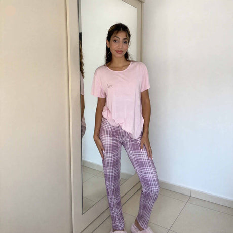 Pale pink short sleeve top with a small chest motif and checked bottoms
