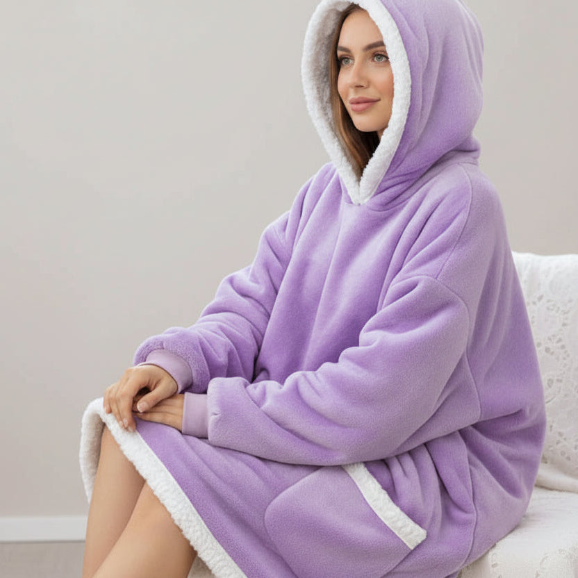 Ribbed cuffs and a broad white sherpa border round the hood, hem and pocket of a lilac blanket