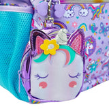 Mini unicorn coin pouch with glitter ears clipped to the backpack